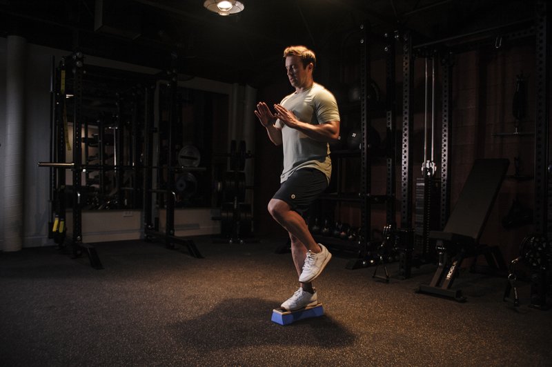Athlete in a ski-specific personal training session on a balance platform in a modern West LA gym